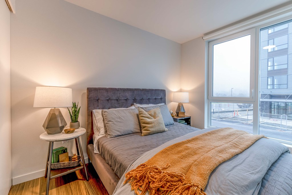 a bedroom with a bed and a large window at Riverfront Everett, Washington