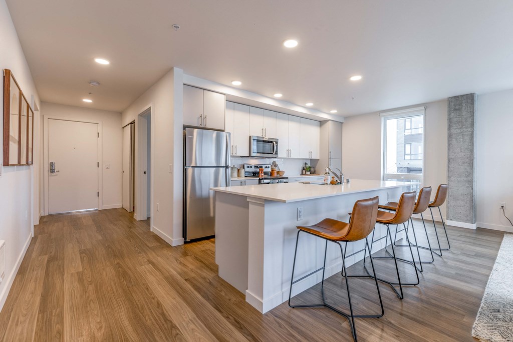 a kitchen with a large island and bar stoolsat Riverfront Everett, Washington