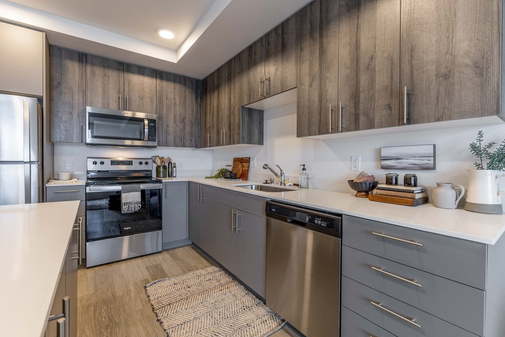 a kitchen with stainless steel appliances and white counter tops at Riverfront Everett, Washington