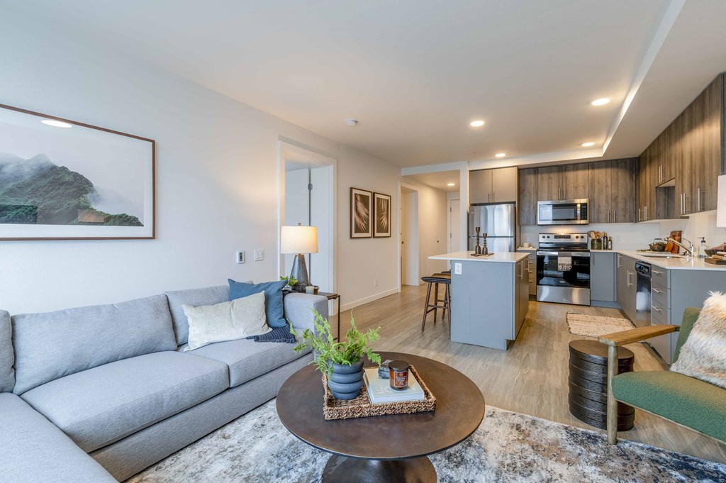 a living room with a couch and a tableat Riverfront Everett, Washington, 98101