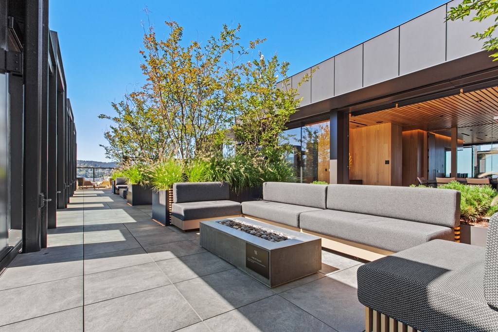 a terrace with couches and a fire pit