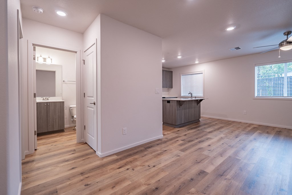 a kitchen and living room in a house with hardwood floors