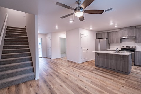 an open floor plan with a staircase leading up to the kitchen and living room