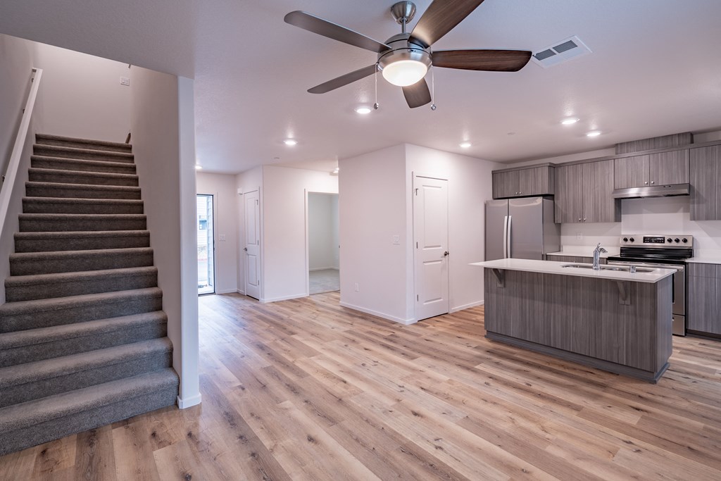 an open floor plan with a staircase leading up to the kitchen and living room