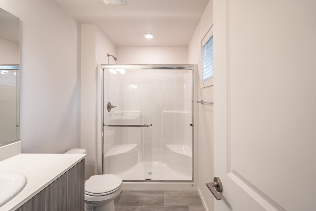 a bathroom with a toilet shower and sink
