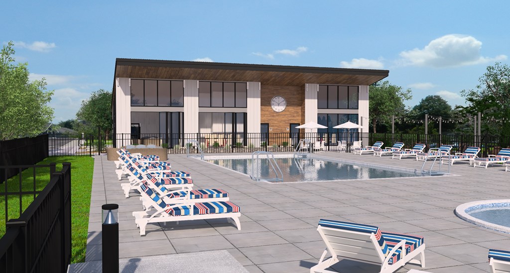 A poolside area with sun loungers and a building in the background.