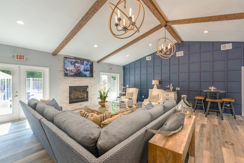 A modern living room with a grey sofa and a wooden coffee table.