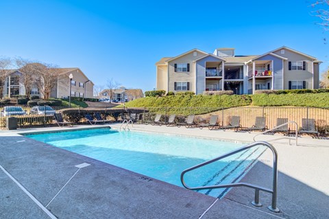 Resort-style swimming pool at Rutland Place Apartment Homes in Macon, Georgia with spacious sundeck and comfortable outdoor seating for residents.