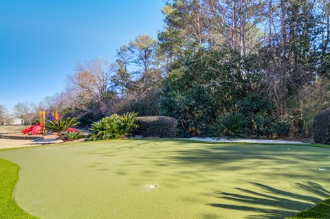 Private golf putting green at Rutland Place Apartment Homes offering residents a unique outdoor recreation amenity in Macon, Georgia.