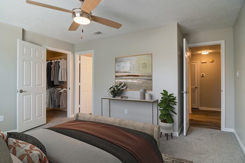 a bedroom with a bed and a ceiling fan