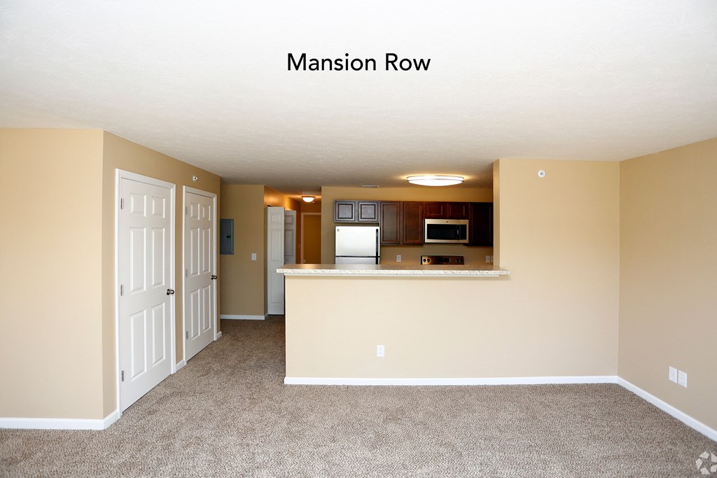a kitchen with a large island and a white door