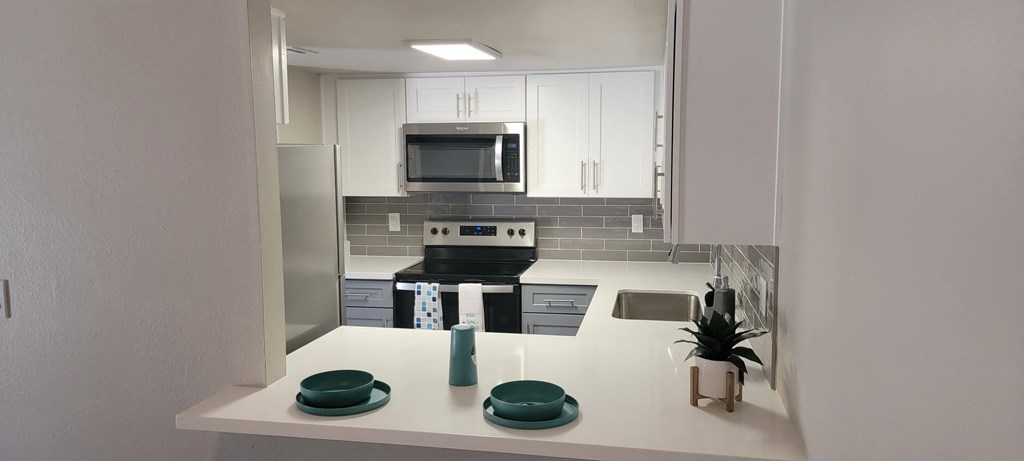 a small kitchen with a stove and a microwave