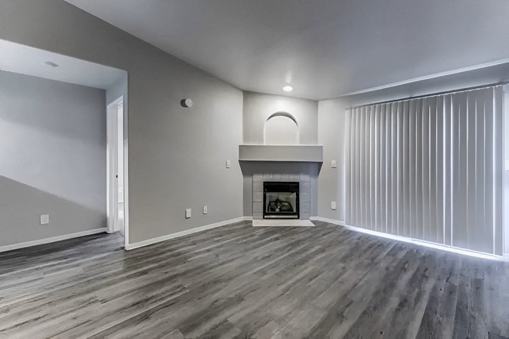 a living room with a fireplace and sliding glass doors
