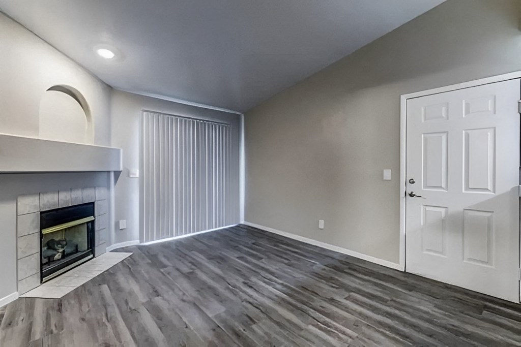 a living room with a fireplace and a white door