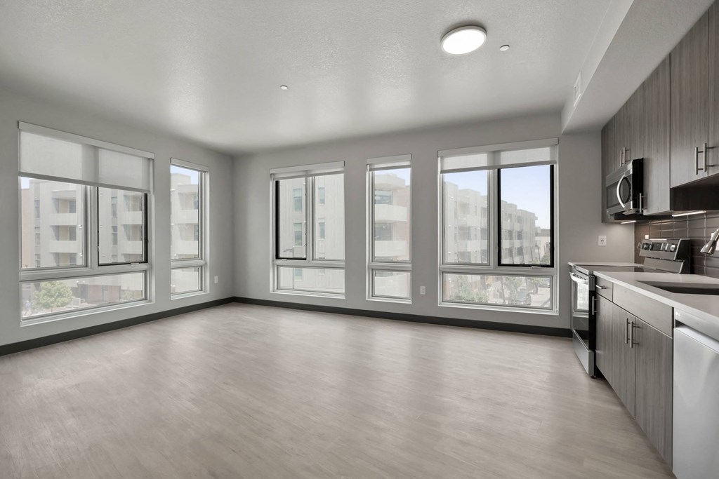 an empty living room with a large window