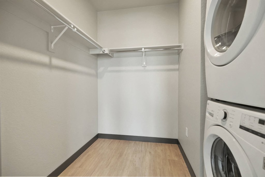 an empty laundry room with a washer and dryer