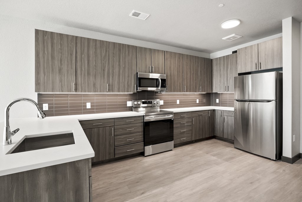 a kitchen with wooden cabinets and stainless steel appliances