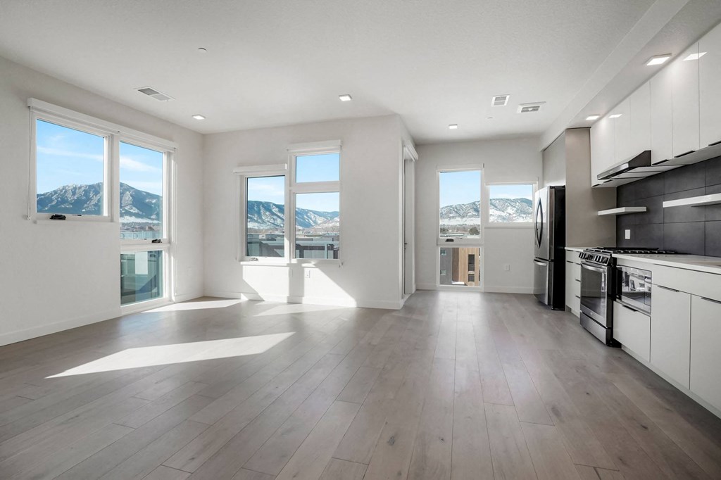 a kitchen with a stove top oven next to a window