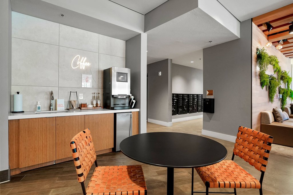 a dining area with a round table and two chairs