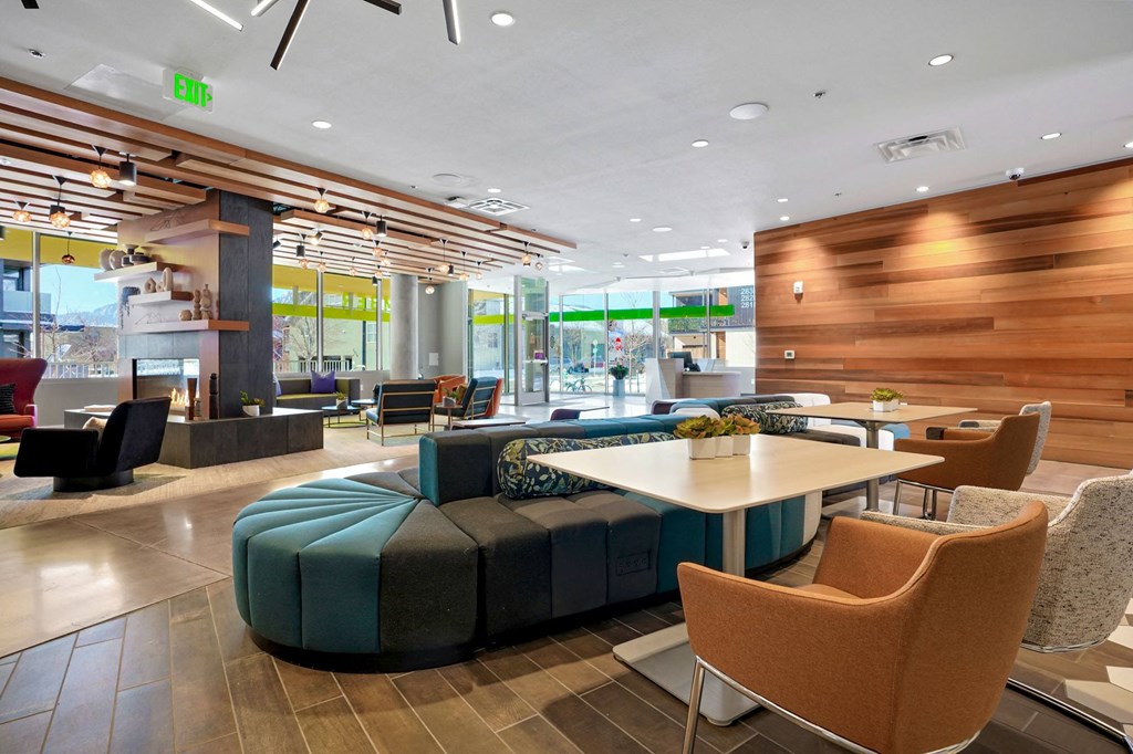 a seating area with a table and chairs in front of a window