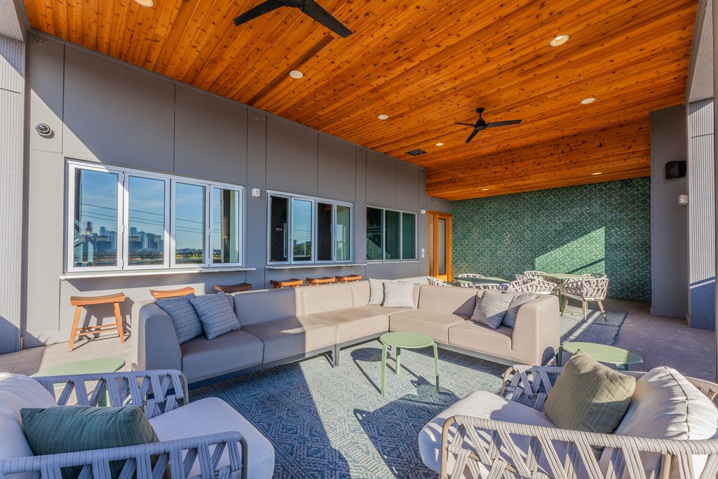 a living room filled with furniture and a wooden ceiling