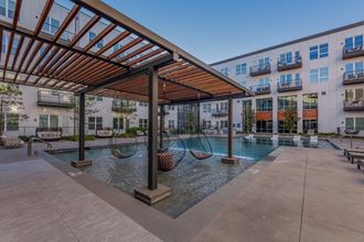 Pet-Friendly Apartments in Downtown Dallas, TX- 4600 Ross- Sparkling Pool with Swinging Chairs and Poolside Couches