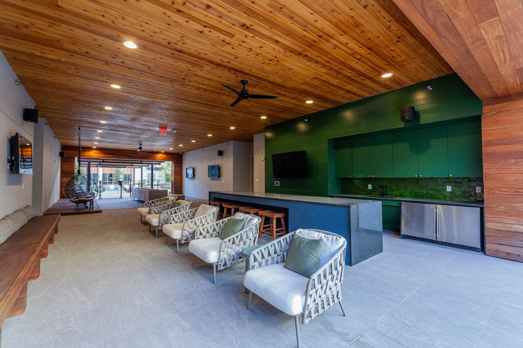 Studios in Old East Dallas, TX - 4600 Ross - Lounge with a Community Kitchen, Various Cozy Seating Options, and Multiple TVs