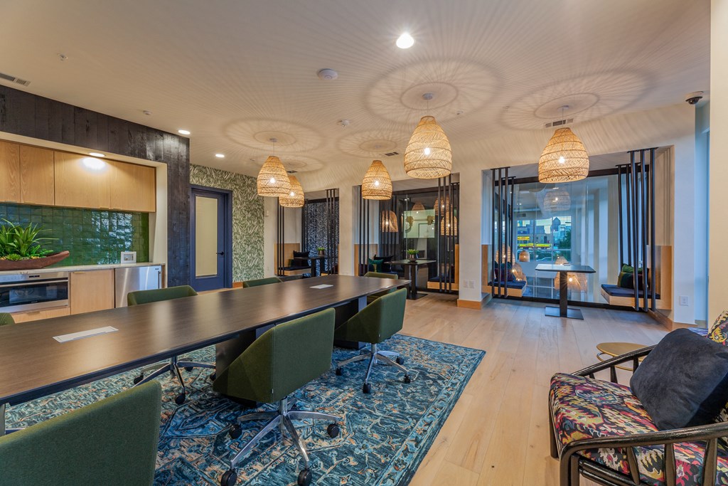 a room with a long table and chairs