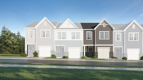 A row of houses with garages and driveways.
