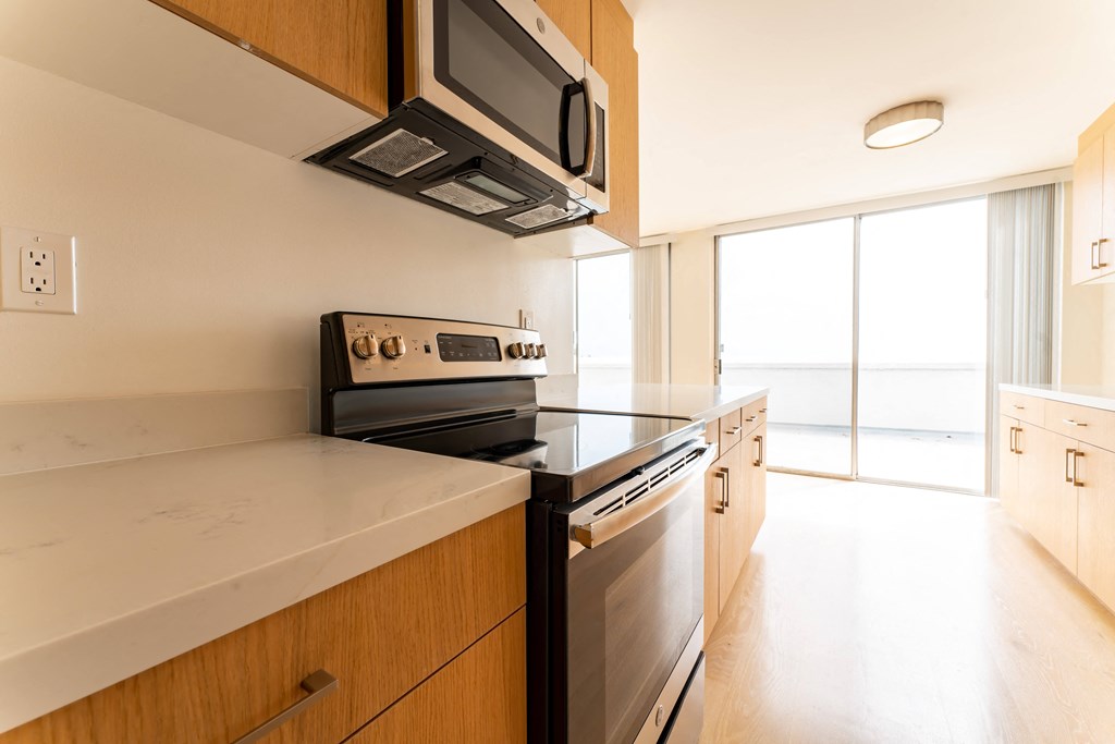a kitchen with a stove and microwave in a 555 waverly unit