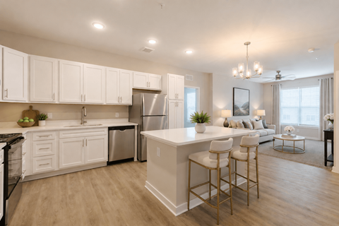 A modern kitchen with white cabinets and a large island.