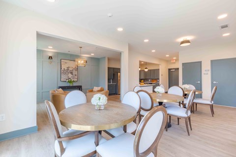 Community dining room with elegant seating for resident gatherings and social events at Sage 5430 in Norcross, GA.