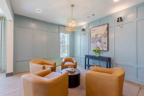 A living room with a grey wall and a painting hanging on it.