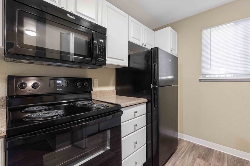 Saratoga Apartments in Everett, WA photo of kitchen with hardwood flooring - Photo Gallery 1
