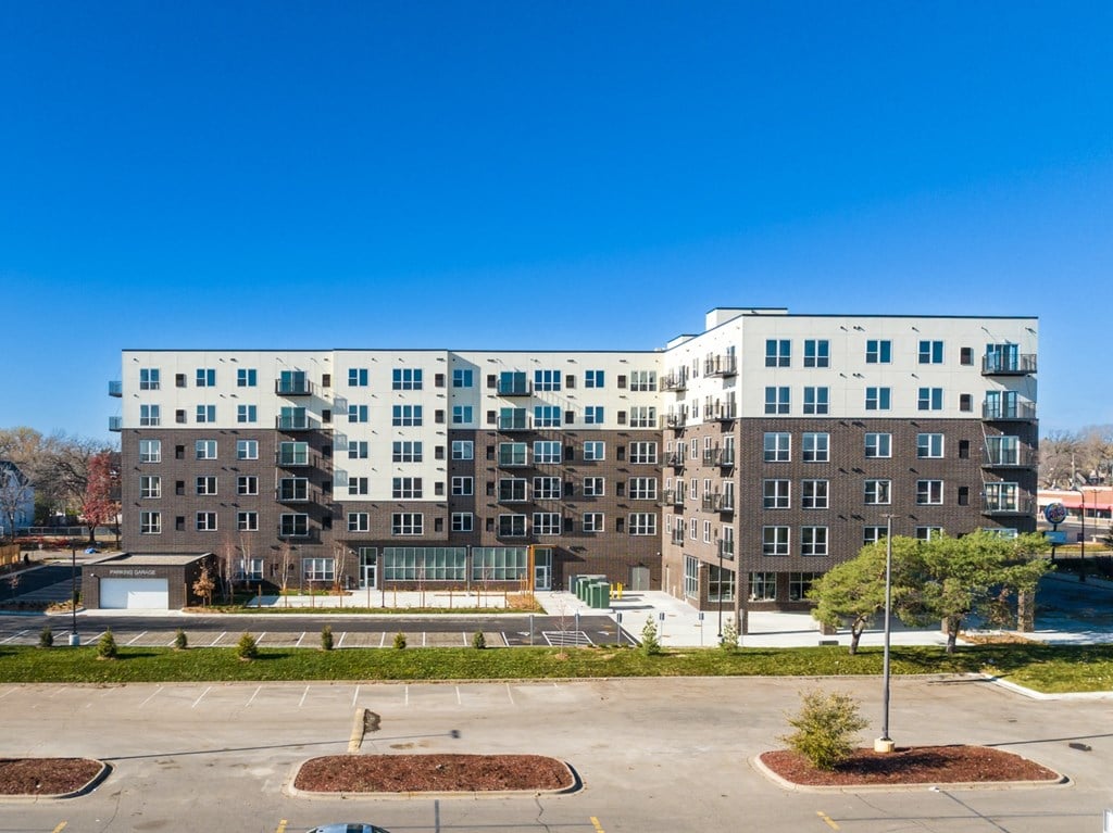 a large apartment building with a fountain in front of it