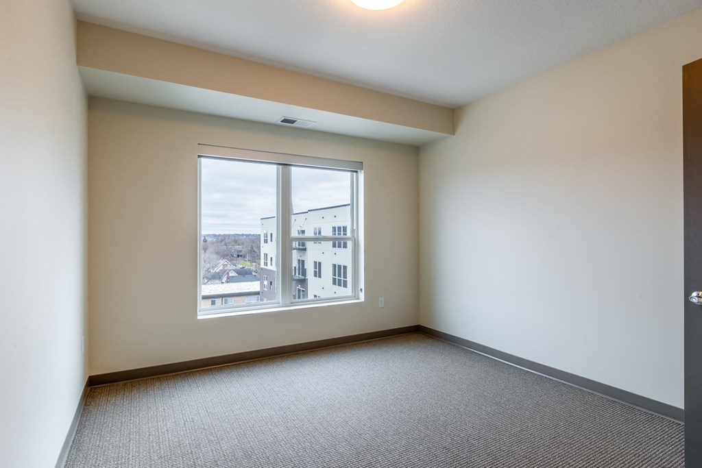 an empty living room with a large window