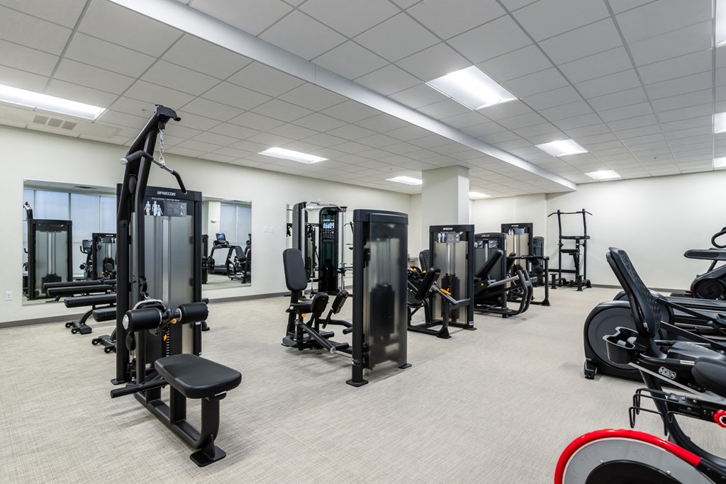a fitness room filled with exercise equipment and weights