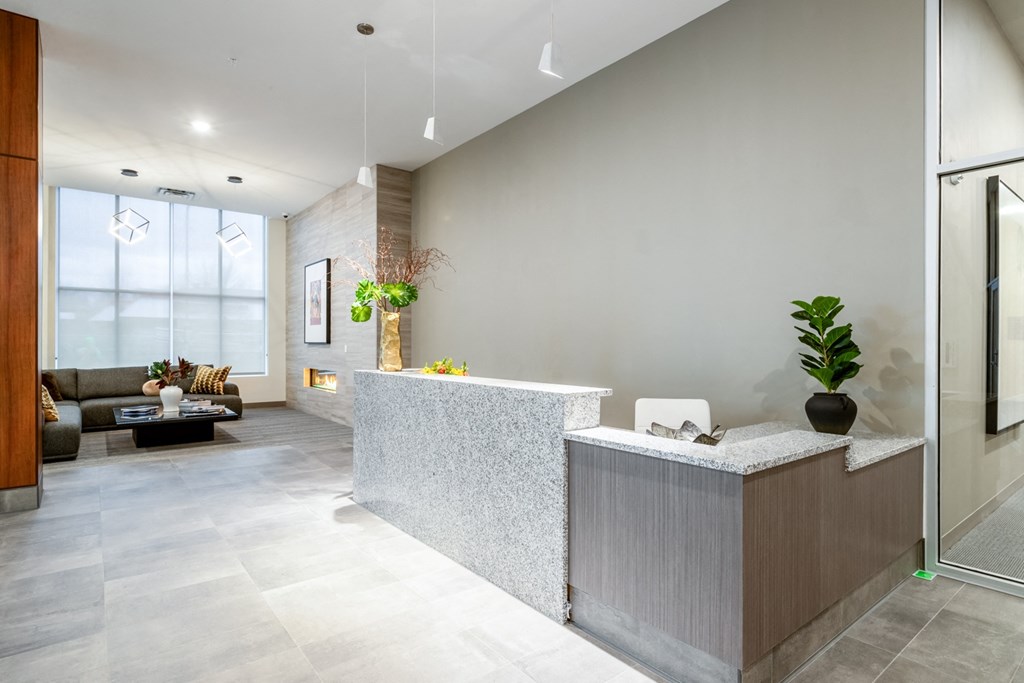 a lobby with a reception desk and a couch