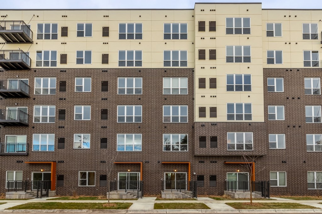 the exterior of an apartment building with windows and balconies