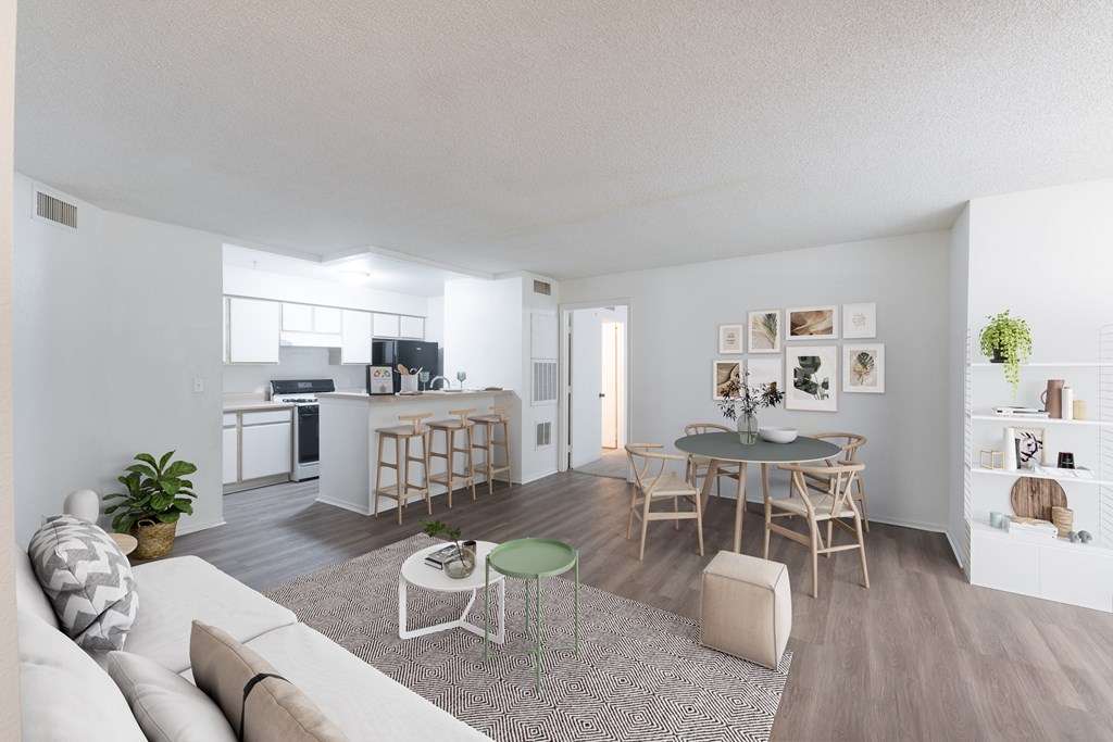 Open-concept living room, dining area, and kitchen at Savannah Sounds apartments in Tallahassee, FL.