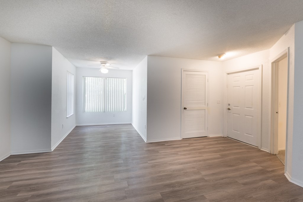 A room with wooden floors and white walls.