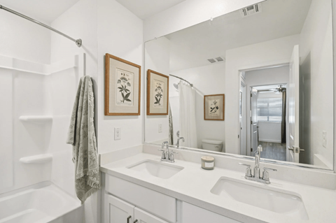 Modern bathroom with double-sink vanity in a new 3-bedroom, 2.5-bath townhome at Villas at 91st in Tolleson