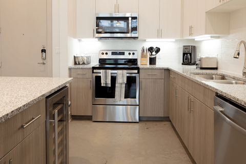 A modern kitchen with a stainless steel oven and microwave above the stove.