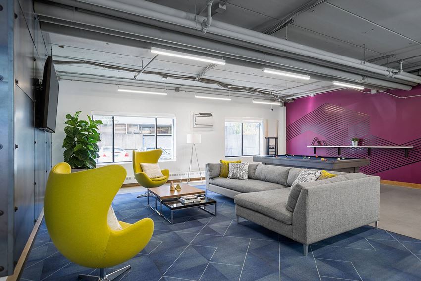 a living room with yellow chairs and a couch