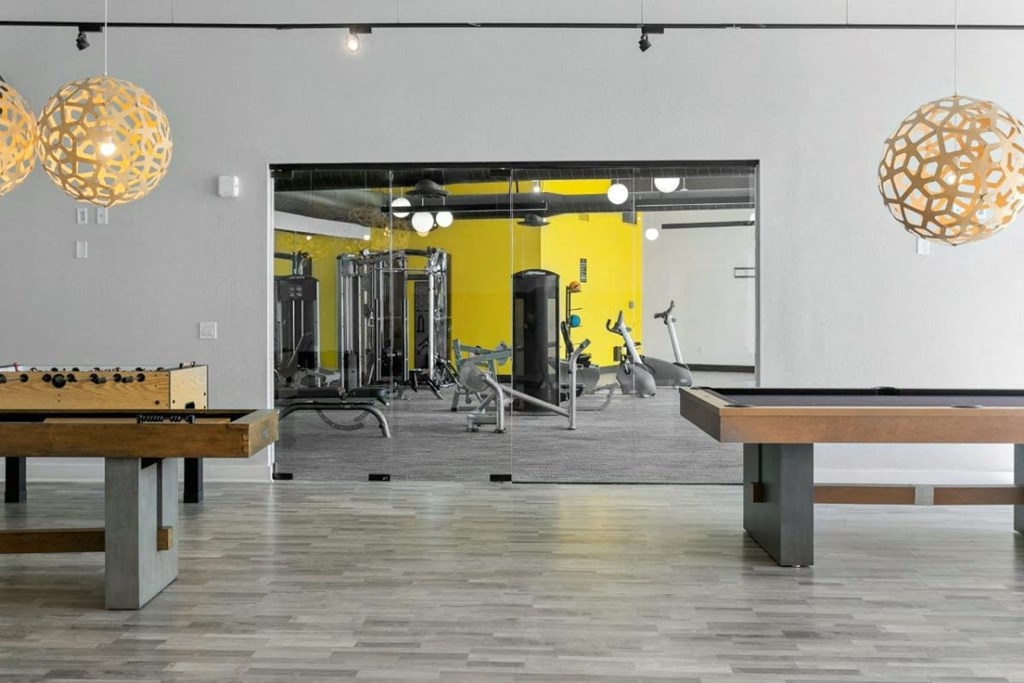 Community game and entertainment room with seating and games at Sentry Tempe apartments in Tempe near Mesa, Arizona