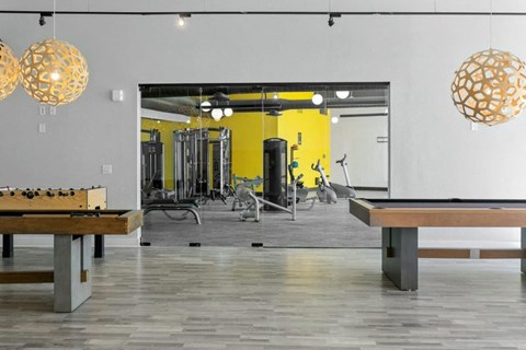 Community game and entertainment room with seating and games at Sentry Tempe apartments in Tempe near Mesa, Arizona