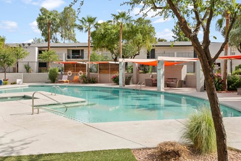 Resort-inspired pool with sun deck and lounge chairs at Sentry Tempe apartments in Tempe near Mesa, Arizona