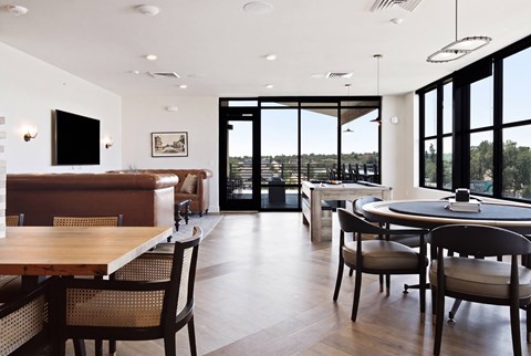 A modern dining room with a wooden table and chairs.