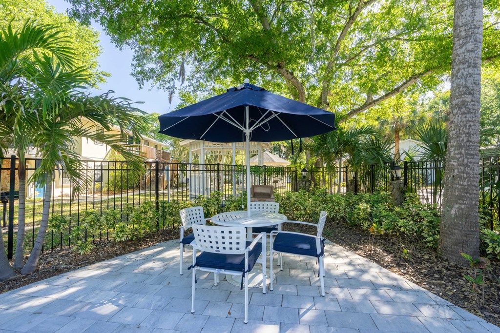 Sherwood Oaks apartments in riverview florida photo of a patio with a table and chairs and an umbrella