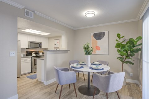 a dining room with a table and chairs and a kitchen